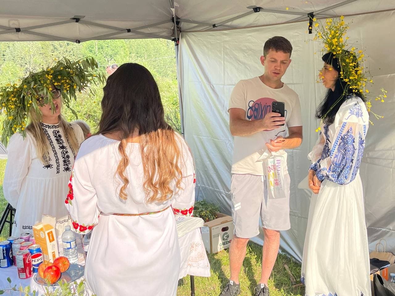 Olha Vozna speaking with a visitor inside the Anytime Accounting tent